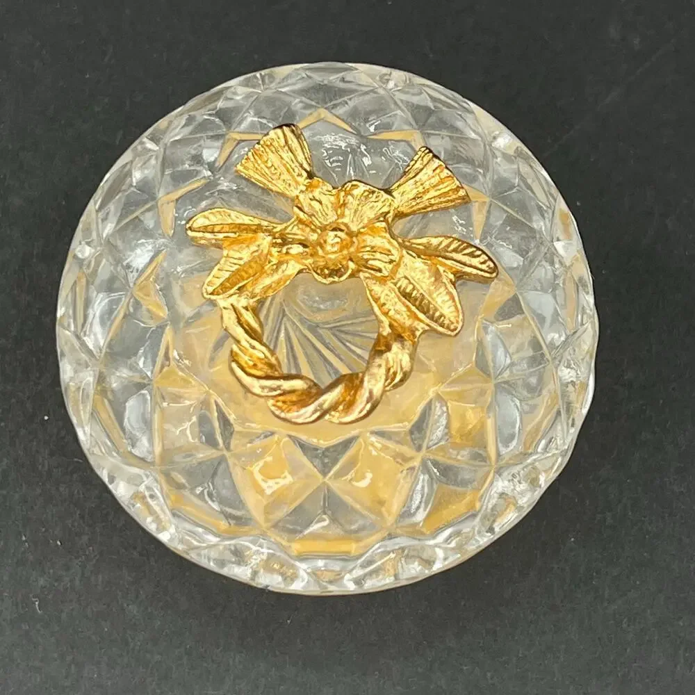 Stylebuilt trinket box, 24K gold plated and a crystal or glass top.